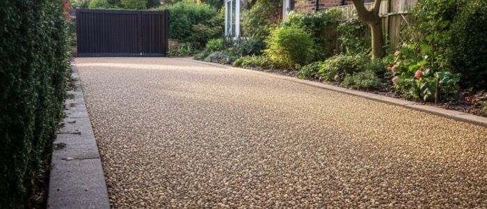 A well-maintained chipseal driveway featuring a layer of gravel, providing a charming and durable path.