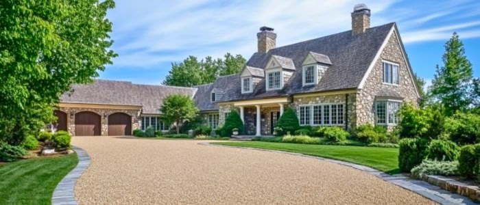 A beautiful home featuring a well-maintained driveway, highlighting the benefits of chip and seal for Connecticut properties.