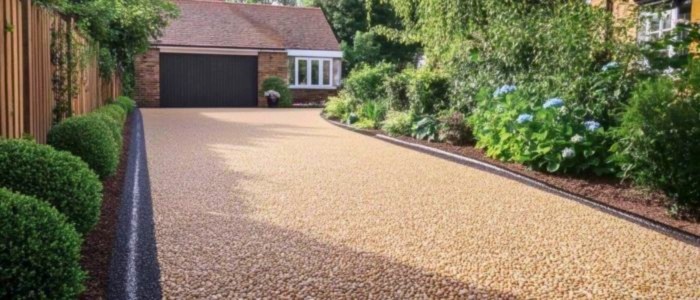 A gravel driveway bordered by bushes, illustrating a common residential landscape design.