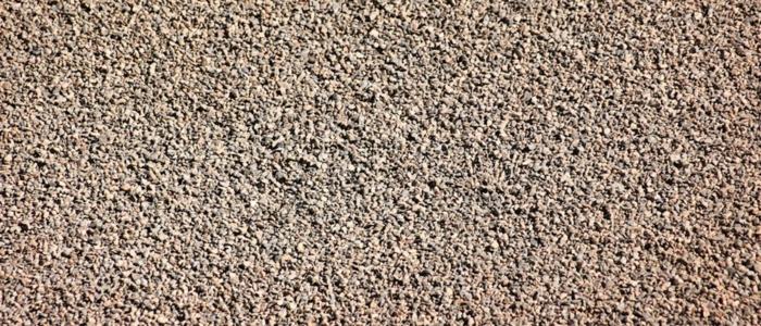 A chip seal highlighting its texture and composition for comparison with gravel materials.