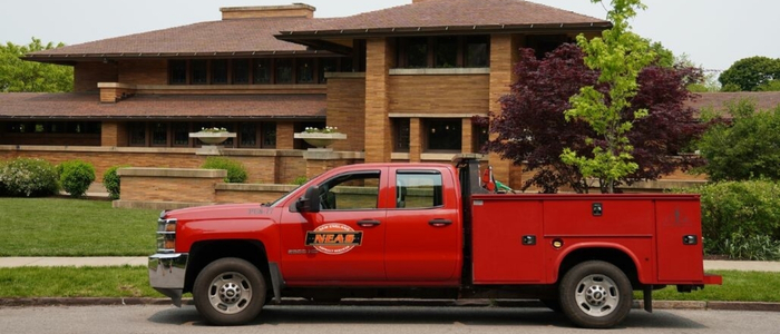 A red truck is parked outside a house, highlighting the oil and stone driveway rejuvenation at Martin House.