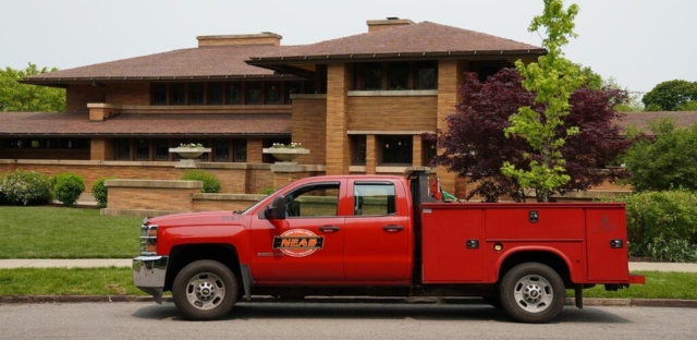 A red truck is parked outside the Martin House, showcasing a typical residential setting.