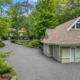 Old Lyme CT chip seal driveway winding through wooded landscaping to a detached garage and residence