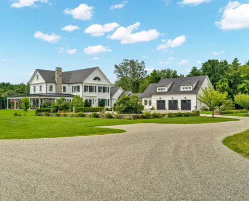 Curved chip seal driveway leading to a landscaped residential driveway in Woodstock CT